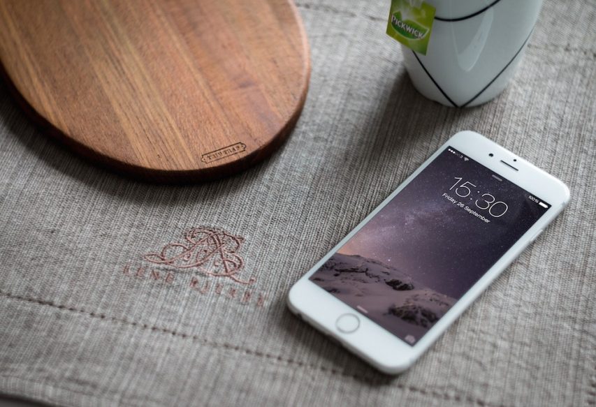 White iPhone 6 on Table Mockup Free PSD